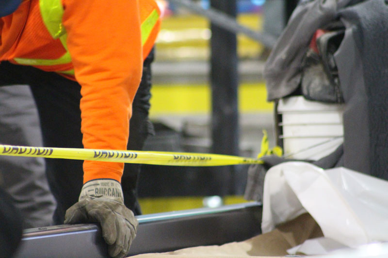 Construction work being performed with caution tape set up to ensure public safety